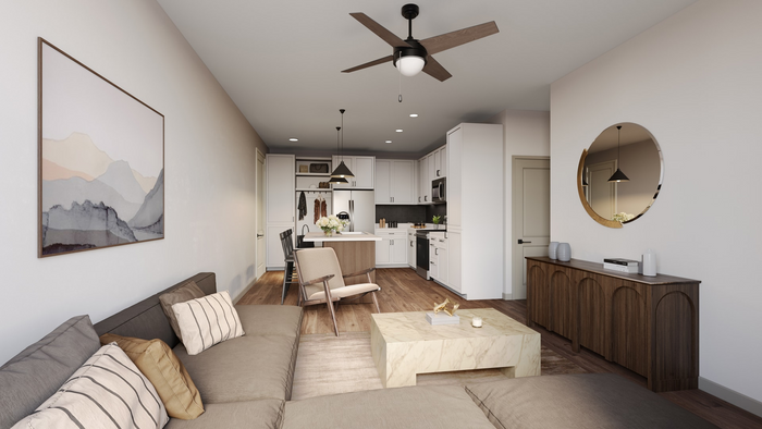 Apartment unit living room with ceiling fan and built-in shelving lighting