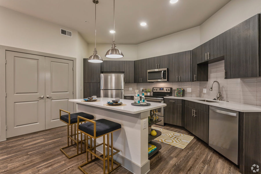 Apartment kitchen with island pendants, under-cabinet lighting and recessed downlights