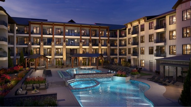 Peterson in Colorado Springs, Colorado - garden-style apartment courtyard and pool lit at dusk