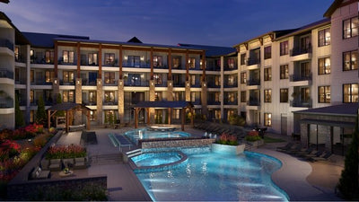 Peterson in Colorado Springs, Colorado - garden-style apartment courtyard and pool lit at dusk